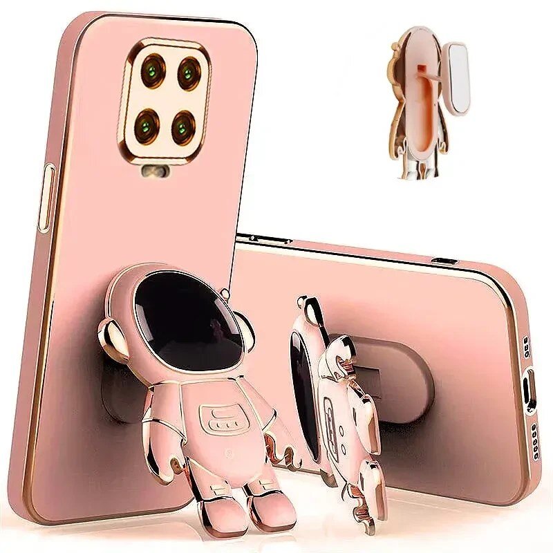 Obraz przedstawia różowe etui na telefon z motywem astronauty, który pełni funkcję uchwytu. Etui ma wycięcia na aparat i porty, a astronauta jest w pozycji stojącej.