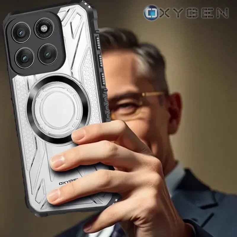 Osoba trzyma w ręku etui na telefon z widocznym logo \'OXYGEN\'. Etui ma srebrny kolor z czarnymi elementami i okrągłym wzorem na środku.