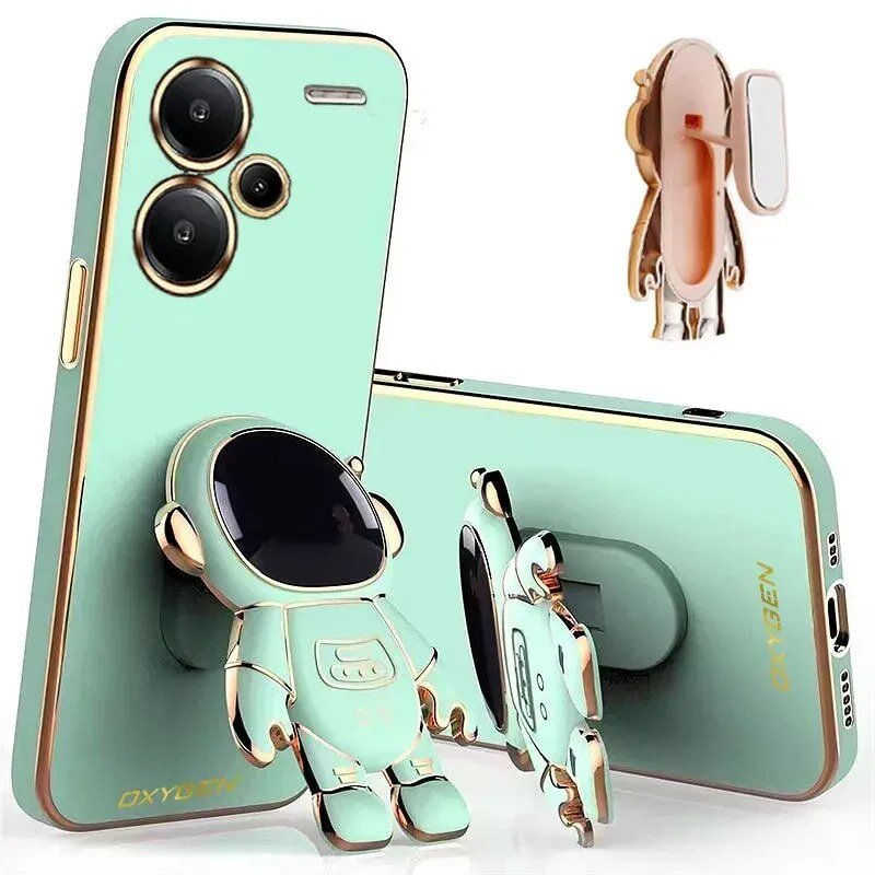 Obraz przedstawia zielone etui na telefon z motywem astronauty, z napisem \'OXYGEN\'. Etui posiada wycięcia na aparat i przyciski oraz stojak w kształcie astronauty.