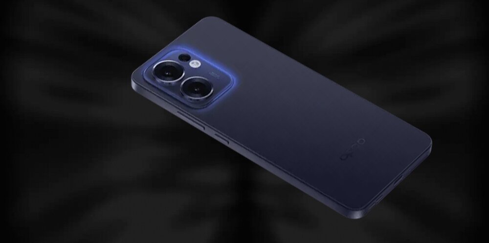 Na obrazie widoczny jest szary smartfon z dwoma dużymi obiektywami aparatu i logo OPPO na obudowie. Tło jest ciemne, co podkreśla kształt i kolor urządzenia.