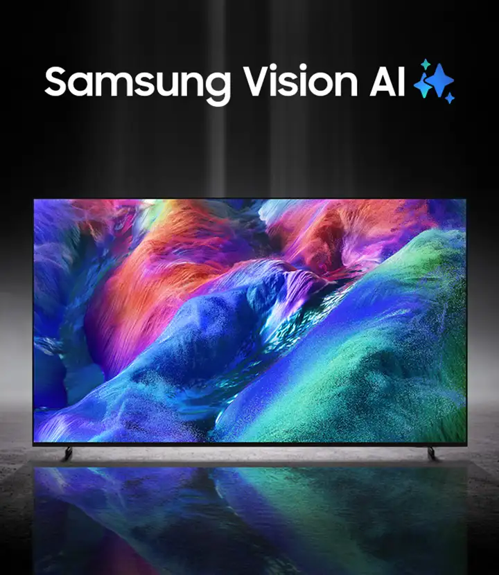 Telewizor wyświetla kolorowy, abstrakcyjny obraz z intensywnymi odcieniami niebieskiego, zielonego i pomarańczowego. Nad ekranem widoczny jest napis \'Samsung Vision AI\' z dwoma niebieskimi gwiazdkami.