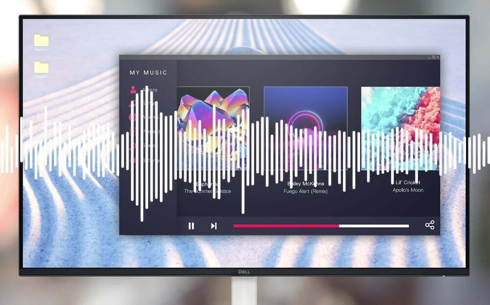 Monitor z wyświetlonym interfejsem odtwarzacza muzyki, na którym widać trzy okładki albumów i wizualizację dźwięku. Na dole ekranu znajduje się logo \'Dell\'.