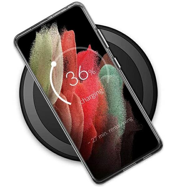 Smartfon w przezroczystym etui leży na okrągłej ładowarce bezprzewodowej. Na ekranie widoczny jest wskaźnik ładowania z napisem \'36% charging - 27 min. remaining\'.