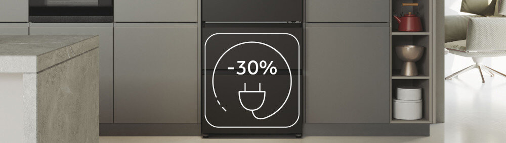 Czarna lodówka z napisem \'-30%\' i symbolem wtyczki na drzwiach, umieszczona w nowoczesnej kuchni z szarymi szafkami.