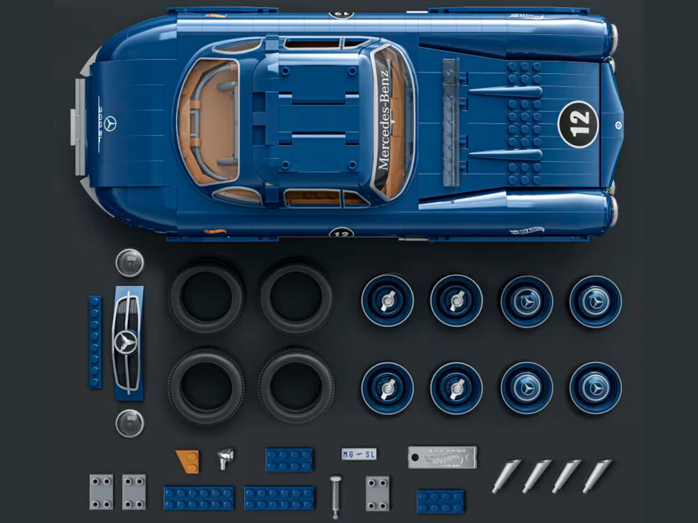 Na obrazie widoczny jest zestaw plastikowych klocków do złożenia modelu samochodu w kolorze niebieskim z napisem \'Mercedes-Benz\' na przedniej szybie. Obok modelu znajdują się dodatkowe elementy, takie jak opony, felgi i klocki konstrukcyjne.