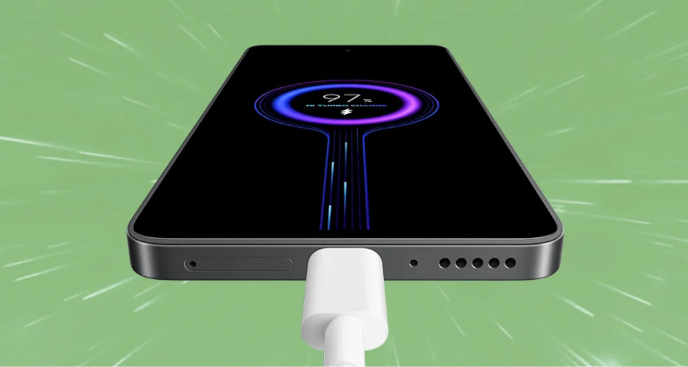 Smartfon z podłączonym kablem ładowania, na ekranie widoczny wskaźnik ładowania na poziomie 97%. Tło jest zielone z efektem promieniowania.