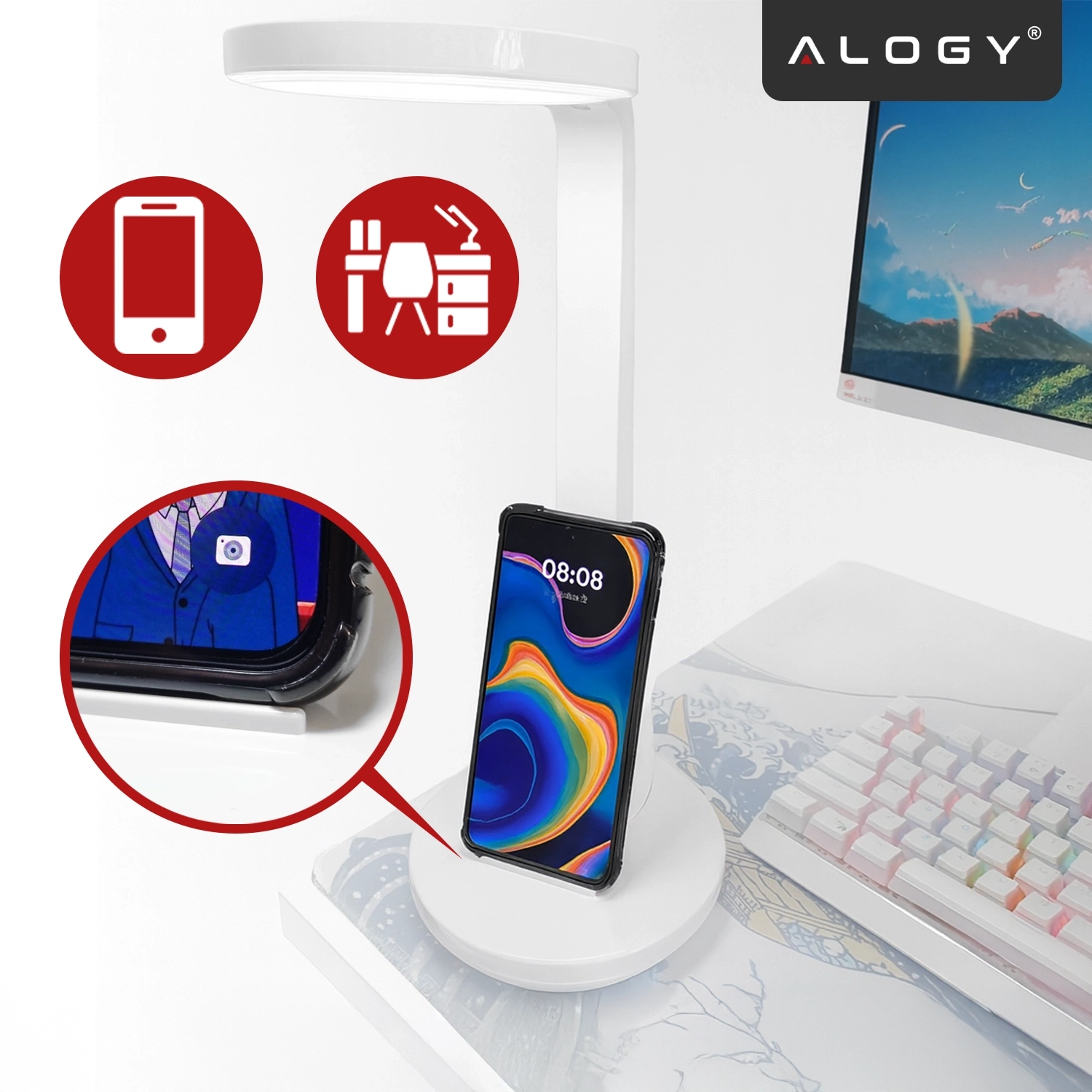 Na biurku znajduje się biała lampka biurkowa z okrągłą podstawą, na której stoi smartfon z kolorowym wyświetlaczem. W górnym rogu widoczne jest logo \'ALOGY\'.