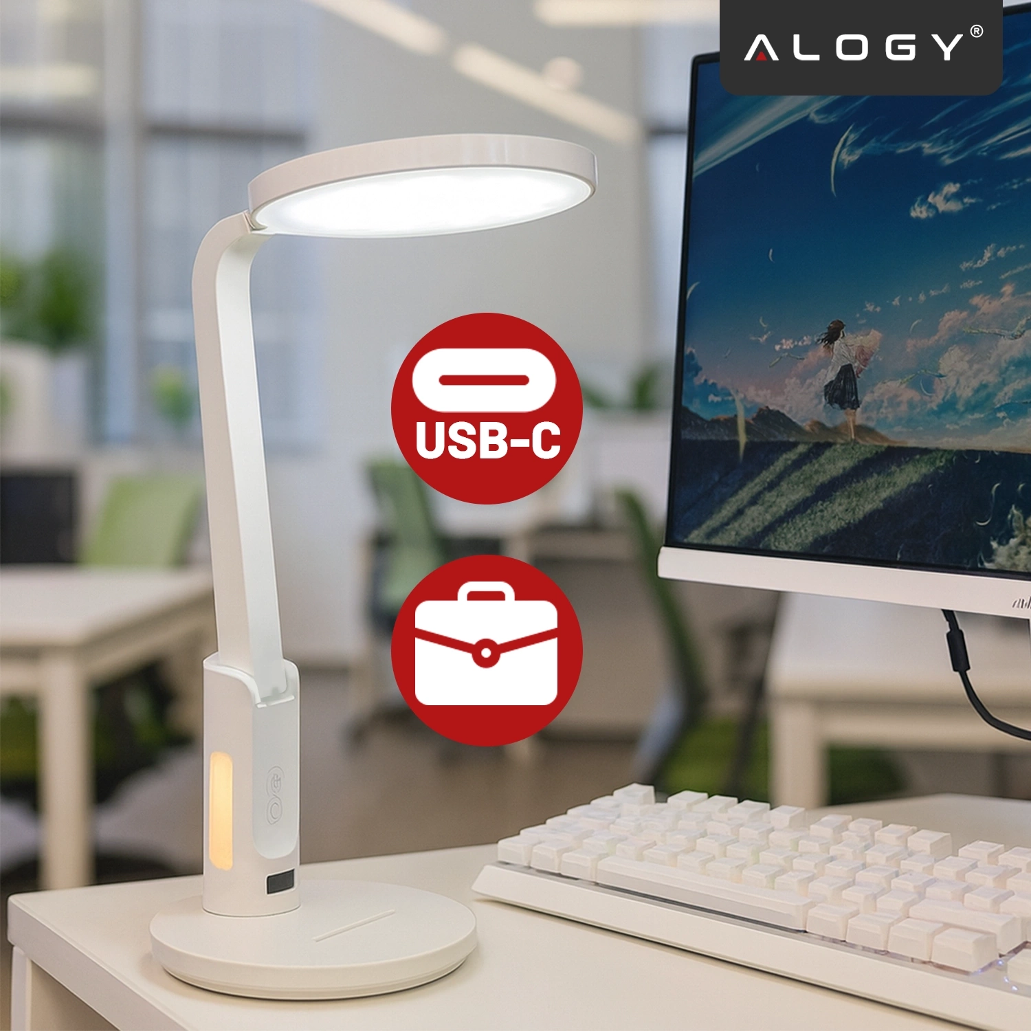 Na biurku znajduje się biała lampka biurkowa LED z okrągłym kloszem, obok monitora i klawiatury. Widoczne są dwa czerwone symbole: USB-C i walizka, a w rogu logo \'ALOGY\'.