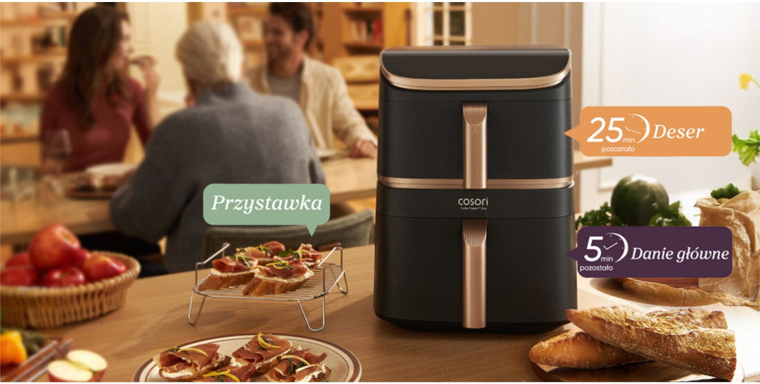 Na stole znajduje się frytkownica beztłuszczowa marki Cosori z dwoma szufladami. Obok widoczne są potrawy oraz napisy: \'Przystawka\', \'25 min Deser\', \'5 min Danie główne\'.