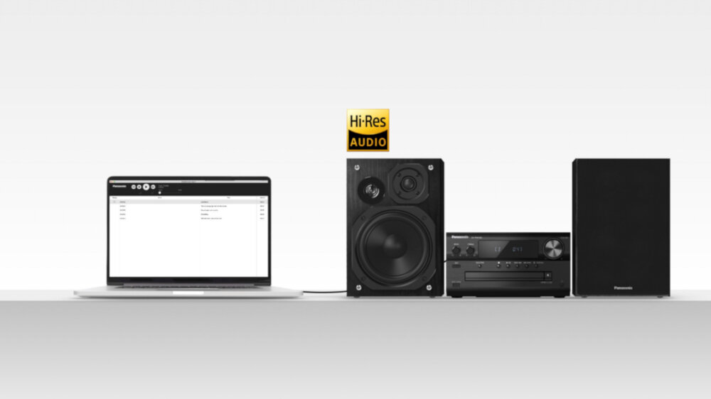Na białym tle znajduje się laptop z otwartym ekranem, obok którego stoi głośnik, wieża audio z widocznym panelem sterowania oraz drugi głośnik. Nad głośnikiem widnieje logo \'Hi-Res AUDIO\'.