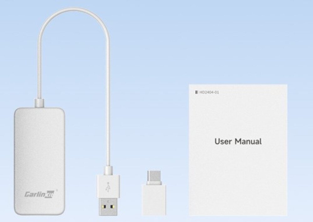 Na obrazie widoczny jest biały adapter z logo \'Carlinkit\', kabel USB, mały adapter oraz instrukcja obsługi z napisem \'User Manual\'.