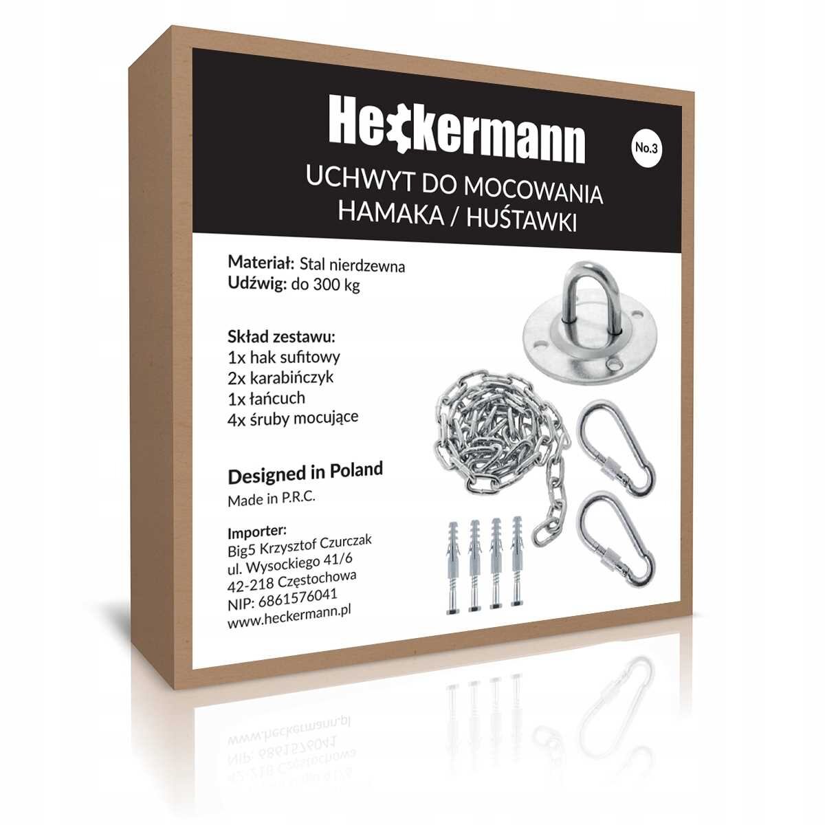 Opakowanie produktu Heckermann z uchwytem do mocowania hamaka lub huśtawki, zawierające informacje o materiale (stal nierdzewna) i udźwigu (do 300 kg). W skład zestawu wchodzą: hak sufitowy, karabińczyki, łańcuch i śruby mocujące.