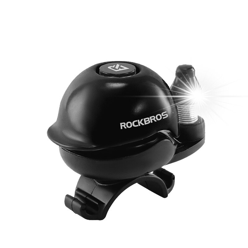 Czarny dzwonek rowerowy z napisem \'ROCKBROS\' i błyszczącym elementem z boku. Na górze widoczne jest logo producenta.