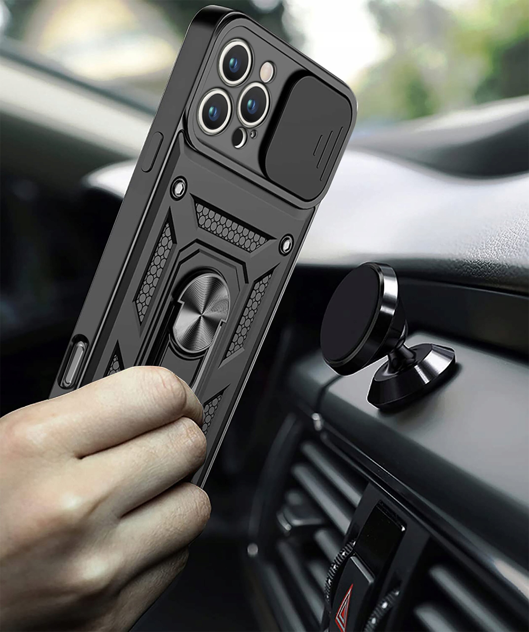 Etui do telefonu z pierścieniem i wzmocnioną konstrukcją trzymane w ręce, obok magnetycznego uchwytu samochodowego na desce rozdzielczej.