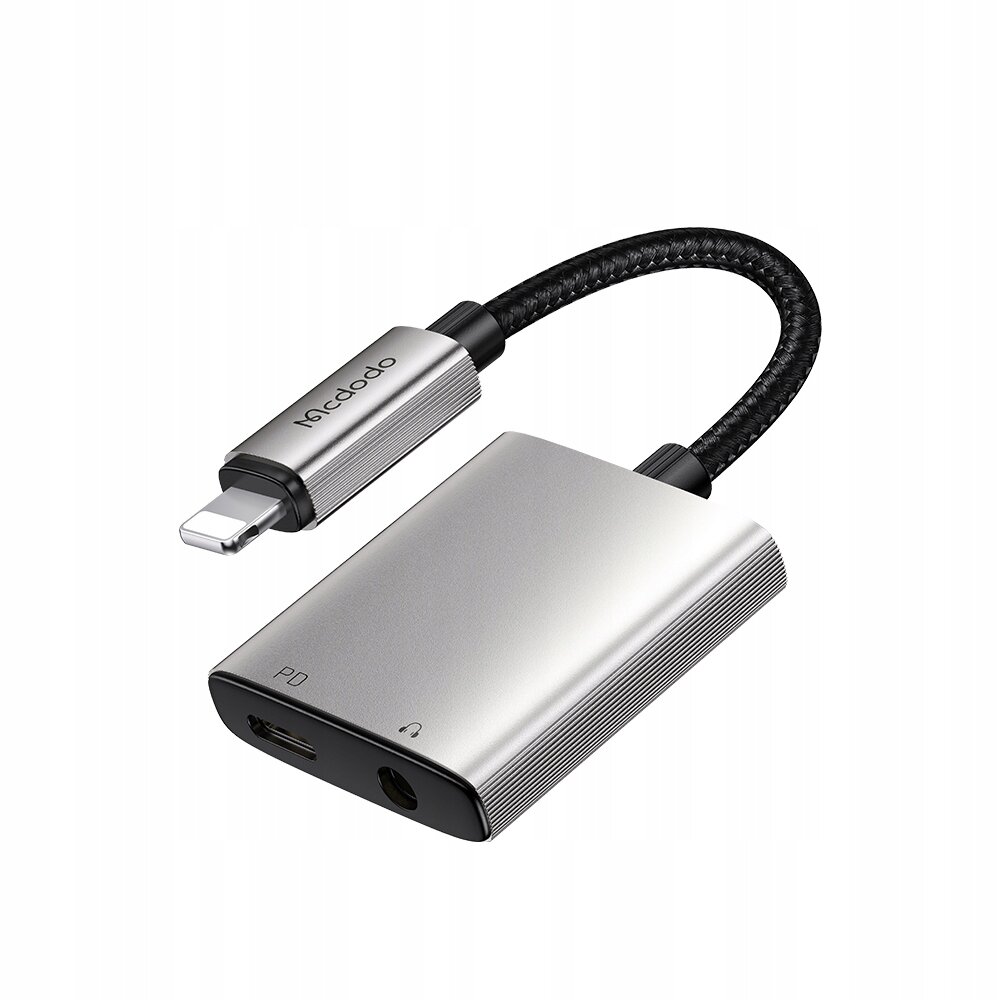 Na obrazie znajduje się srebrny adapter z logo \'Mcdodo\', posiadający złącze Lightning oraz porty PD i mini jack 3,5 mm.