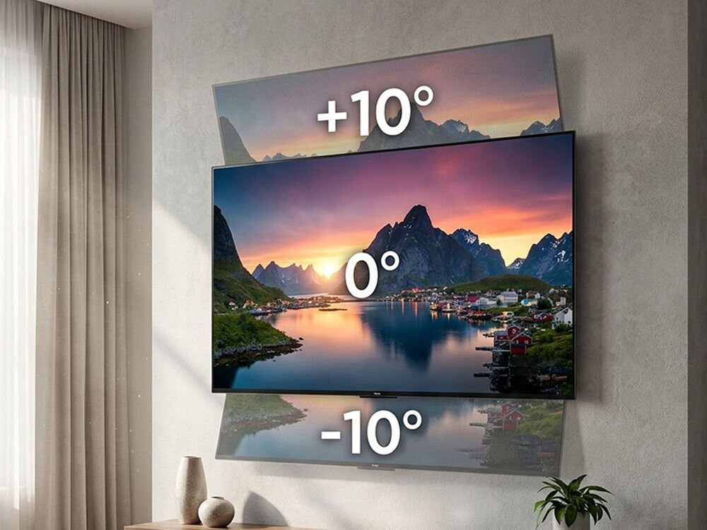 Telewizor zamontowany na ścianie z możliwością regulacji kąta nachylenia, oznaczony wartościami +10°, 0°, -10°. W tle widoczny jest krajobraz z górami i wodą o zachodzie słońca.