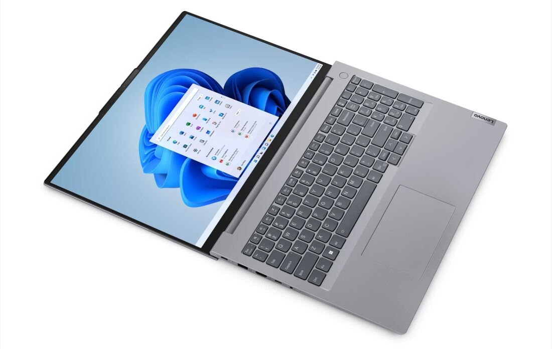 Laptop z otwartym ekranem, na którym widoczny jest interfejs systemu Windows 11. Obok klawiatury znajduje się logo \'Lenovo\'.