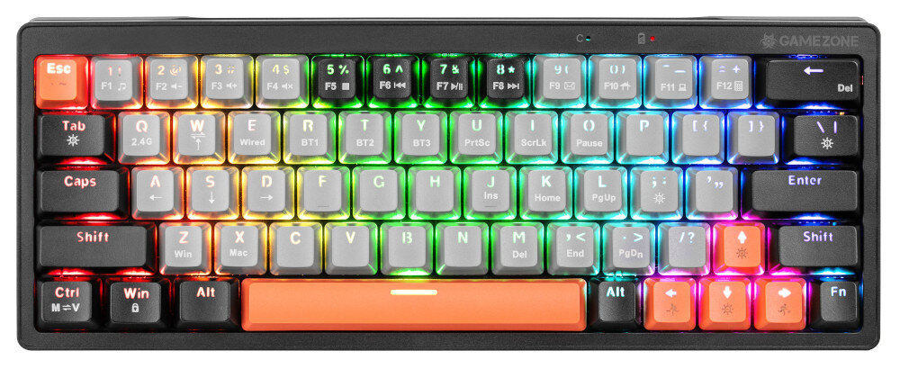 Klawiatura z podświetleniem RGB, posiada klawisze w różnych kolorach, w tym pomarańczowy klawisz spacji. Widoczne są oznaczenia takie jak \'GAMEZONE\' oraz symbole na klawiszach funkcyjnych.