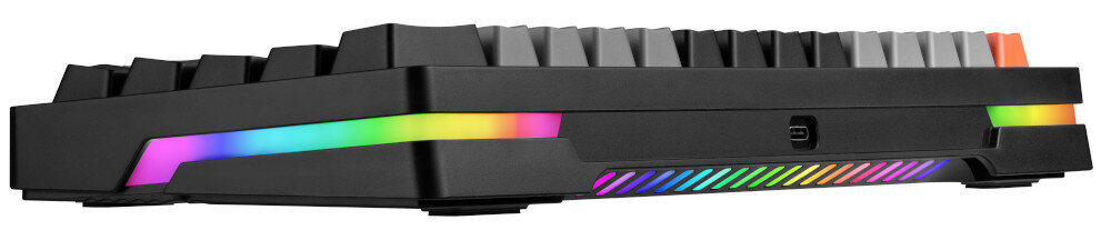 Klawiatura mechaniczna z czarną obudową i podświetleniem RGB wzdłuż bocznej krawędzi. Widoczne są szare i pomarańczowe klawisze.