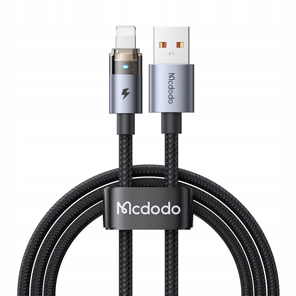 Na obrazie widoczny jest czarny kabel USB z końcówką Lightning, posiadający metalowe złącza i oznaczenie \'Mcdodo\'. Kabel jest opleciony materiałem i ma widoczne logo \'Mcdodo\' na opasce spinającej.