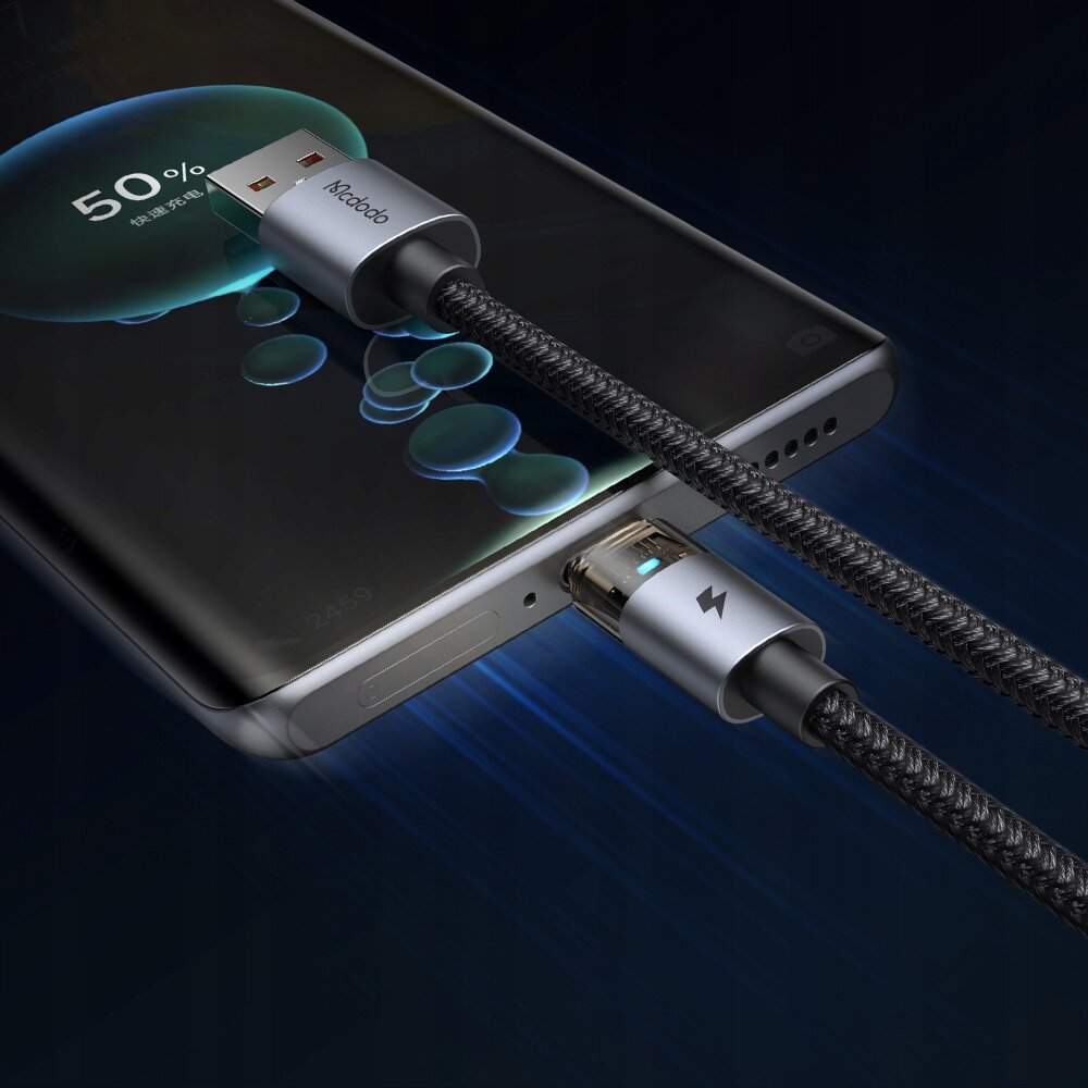 Zdjęcie przedstawia kabel USB-A do USB-C podłączony do smartfona, na ekranie którego widoczny jest wskaźnik ładowania na poziomie 50%. Na wtyczce USB-A znajduje się logo \'Mcdodo\'.