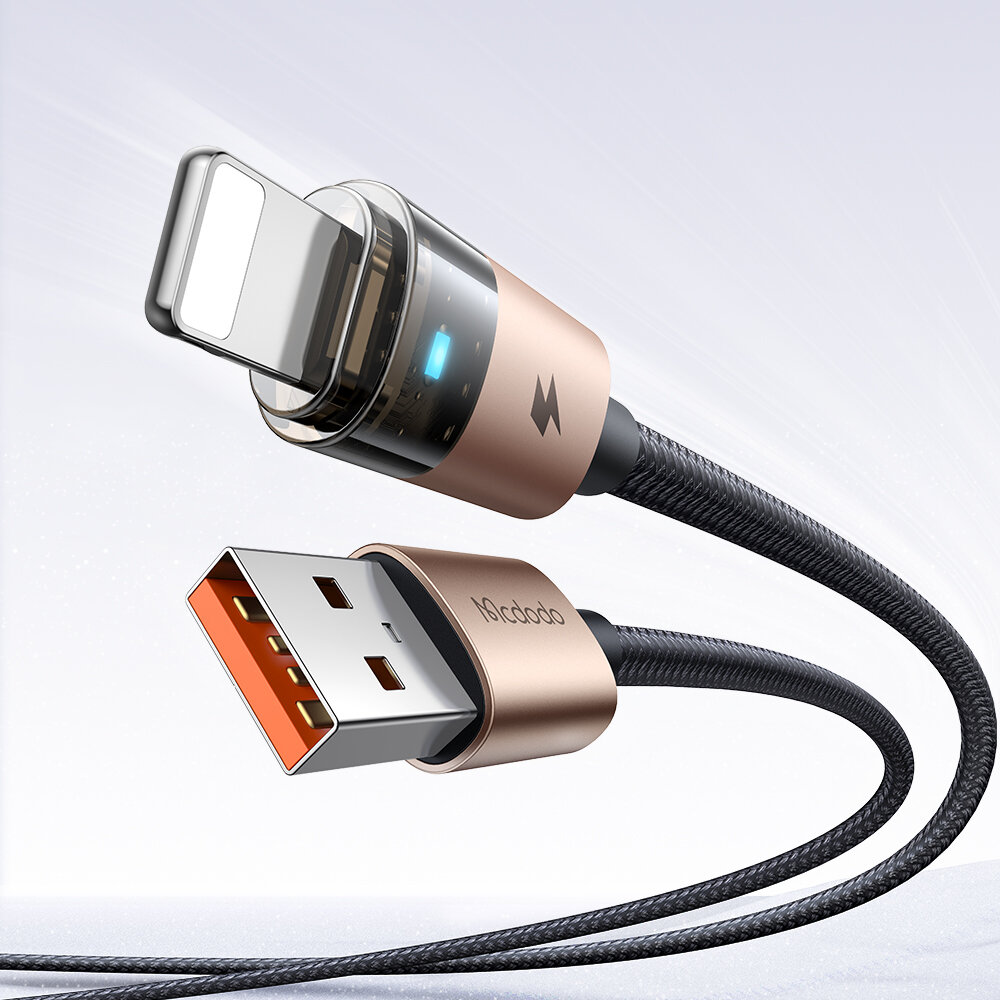 Złoty kabel USB z końcówką Lightning i USB, z widocznym logo \'Mcdodo\' oraz niebieskim wskaźnikiem LED na tle neutralnym.