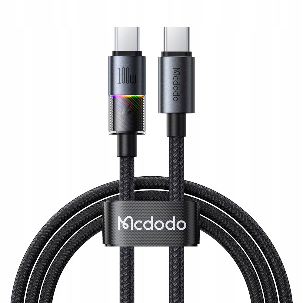 Na obrazie widoczny jest czarny kabel USB-C z plecionym oplotem, oznaczony napisem \'100W\' i \'Mcdodo\'. Kabel jest spięty opaską z logo \'Mcdodo\'.