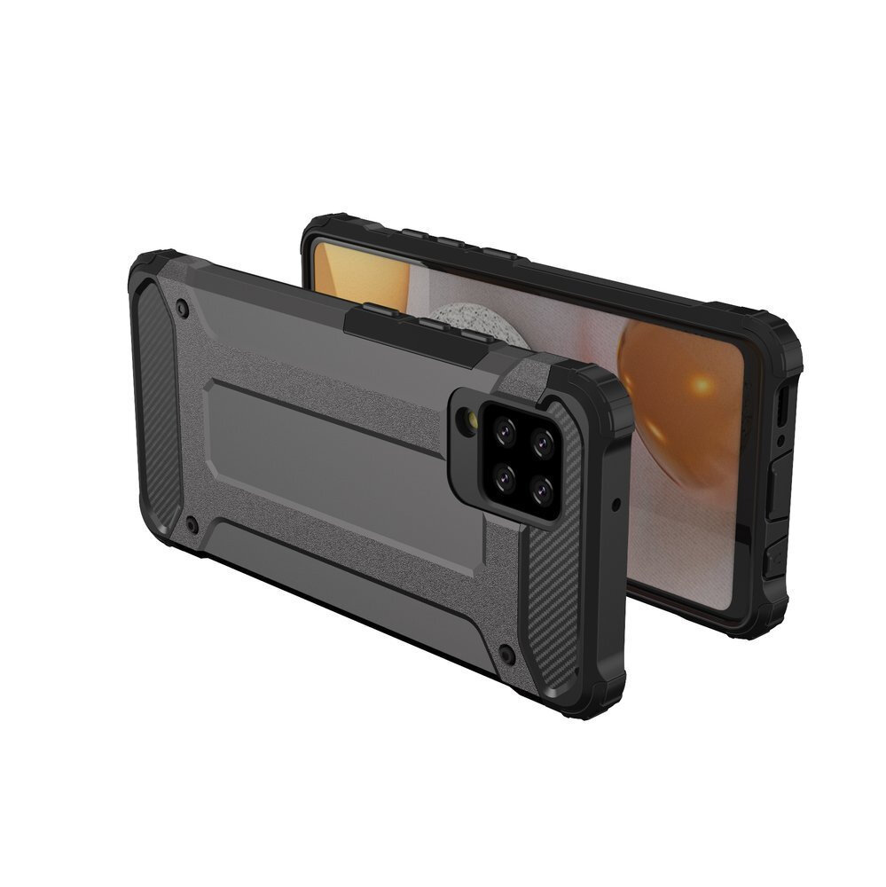 Na obrazie widoczne jest srebrne, pancerne etui na telefon z wyraźnymi wzmocnieniami na rogach. Etui jest założone na telefon, którego ekran jest częściowo widoczny.