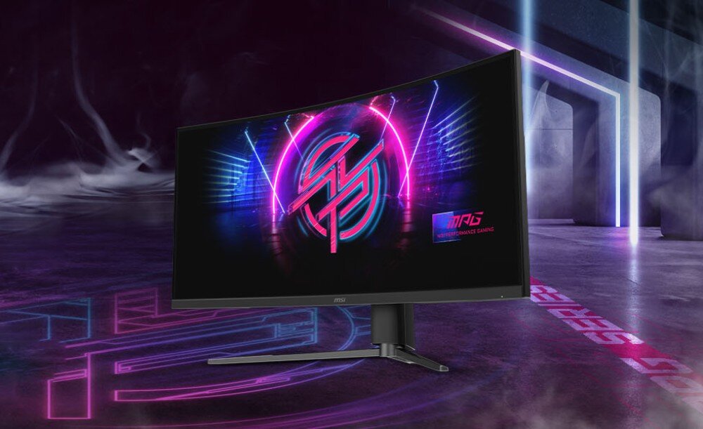 Monitor z zakrzywionym ekranem wyświetla kolorową grafikę z neonowymi elementami. Na ekranie widoczne jest logo \'MPG\'.