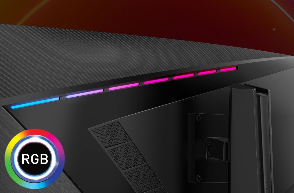 Obraz przedstawia tylną część monitora z podświetleniem RGB w kolorach niebieskim, fioletowym i różowym. W lewym dolnym rogu widoczne jest okrągłe logo z napisem \'RGB\'.
