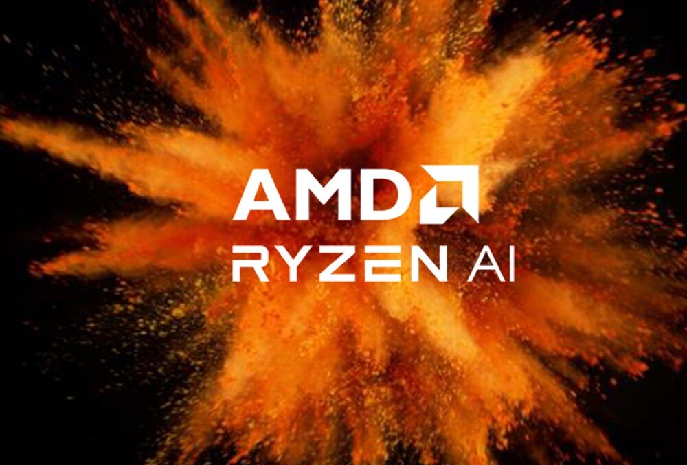 Komputer All in One ASUS VM640KA-BPC019W Logotyp 'AMD RYZEN AI' umieszczony na tle pomarańczowo-czerwonego wybuchu pyłu na czarnym tle