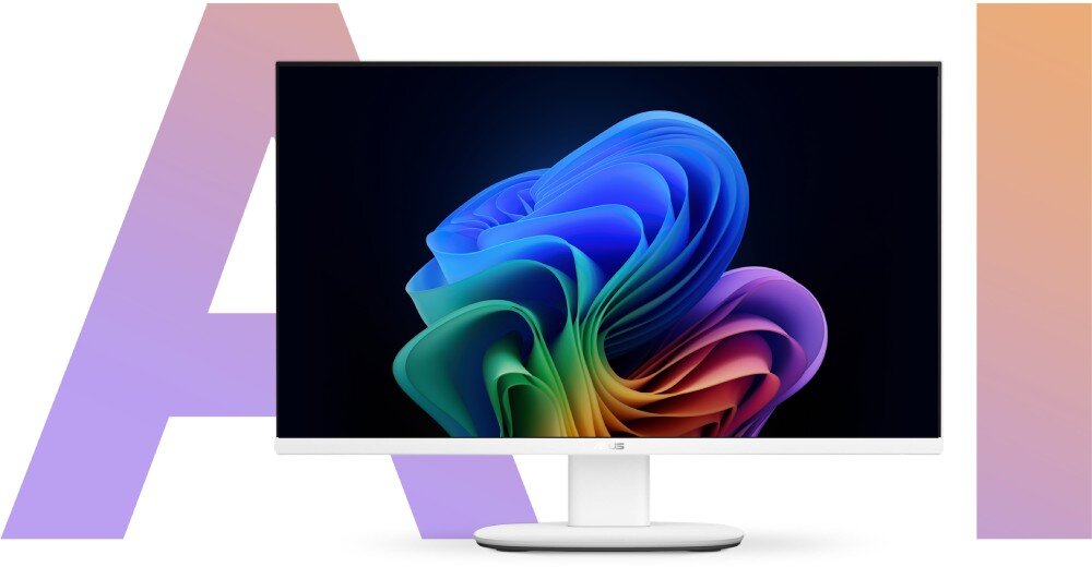 Monitor komputerowy z kolorową grafiką na ekranie, umieszczony na białej podstawie. W tle widoczne są duże litery \'A\' i \'I\' w pastelowych kolorach.
