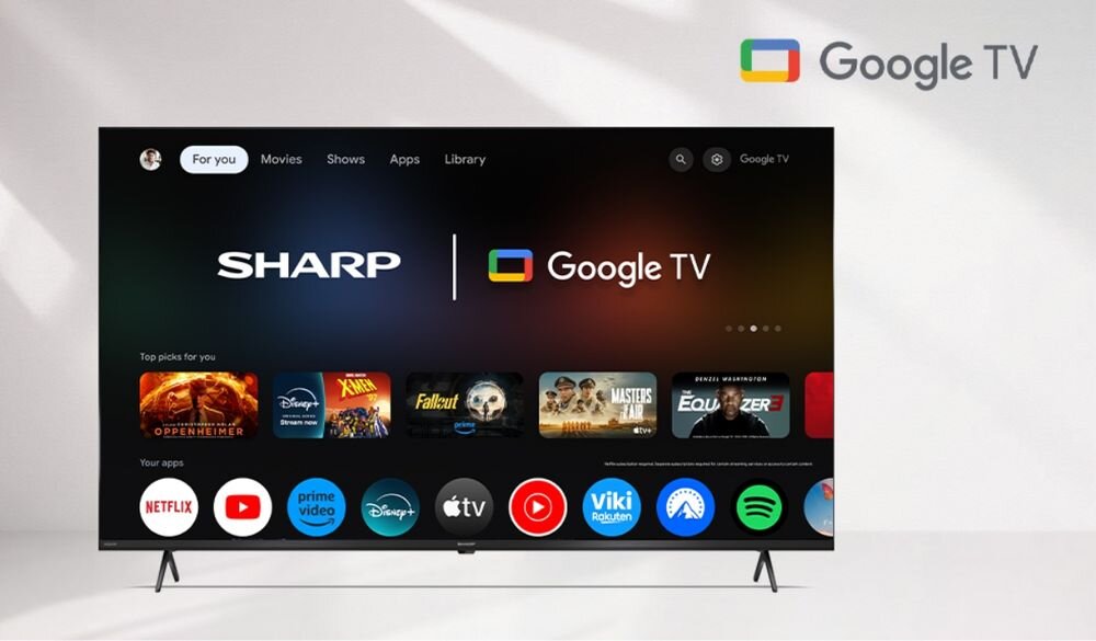 SHARP 70HL4465E Google TV aplikacje streamingowe Netflix Disney HBO Max, telewizor stojący na białej podłodze