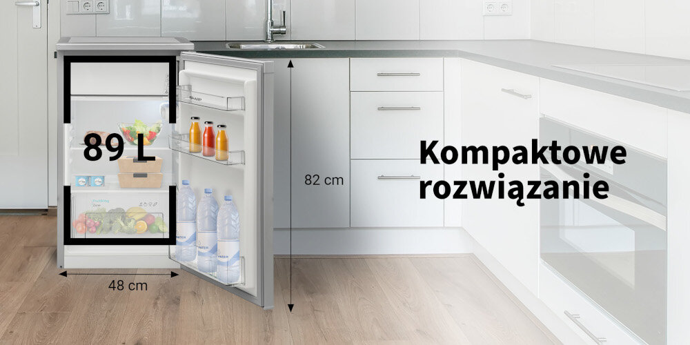 Otwarta lodówka z napojami i warzywami, z oznaczeniem pojemności 89 L oraz wymiarami 48 cm szerokości i 82 cm wysokości. Obok napis \'Kompaktowe rozwiązanie\'.
