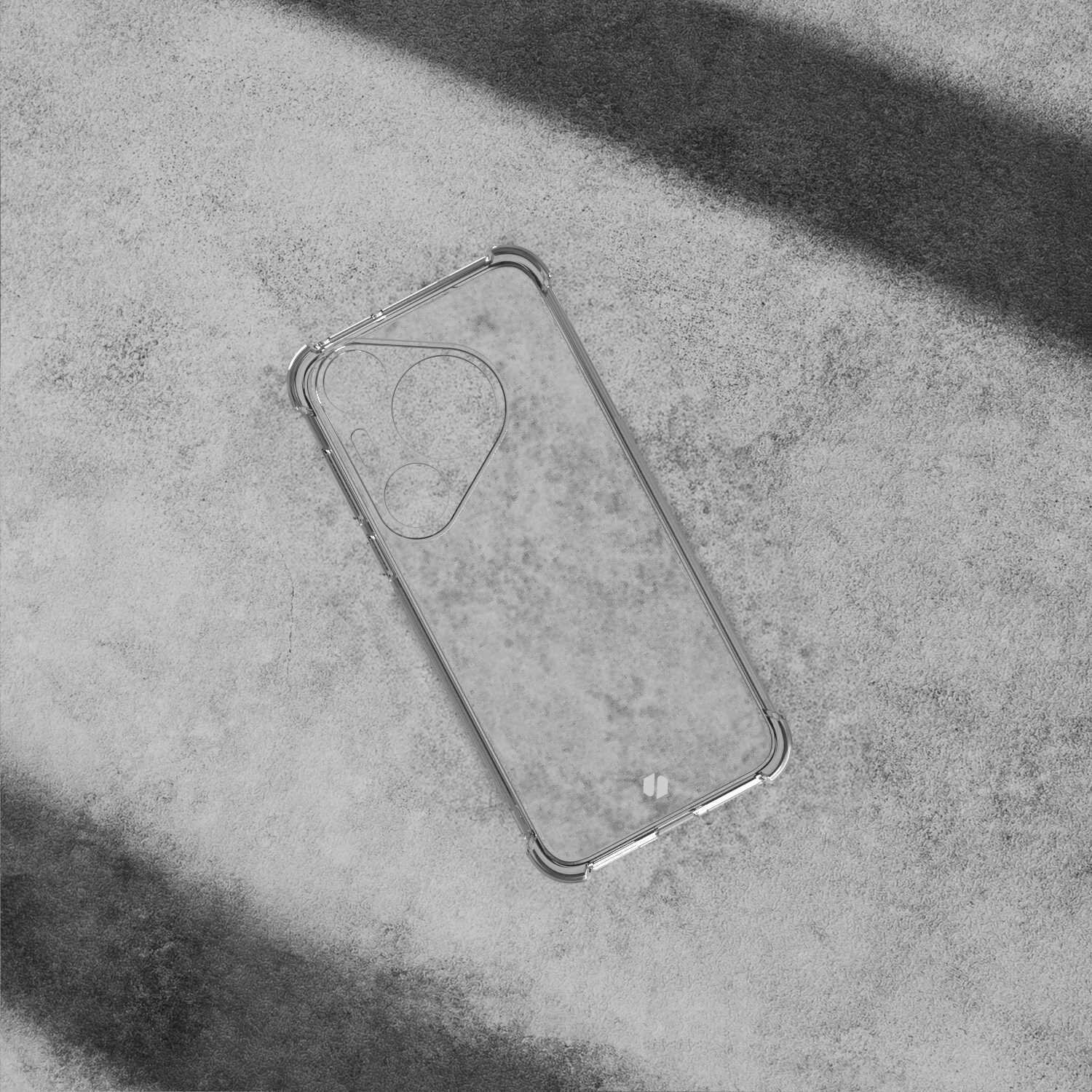 Przezroczyste silikonowe etui na telefon z zaokrąglonymi narożnikami, leży na betonowej powierzchni. Etui ma wycięcia na aparat i przyciski.
