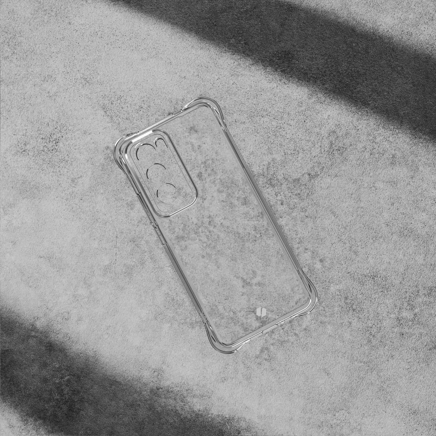 Przezroczyste silikonowe etui na telefon z wycięciami na aparat, leży na szarej powierzchni. Etui ma wzmocnione narożniki dla dodatkowej ochrony.