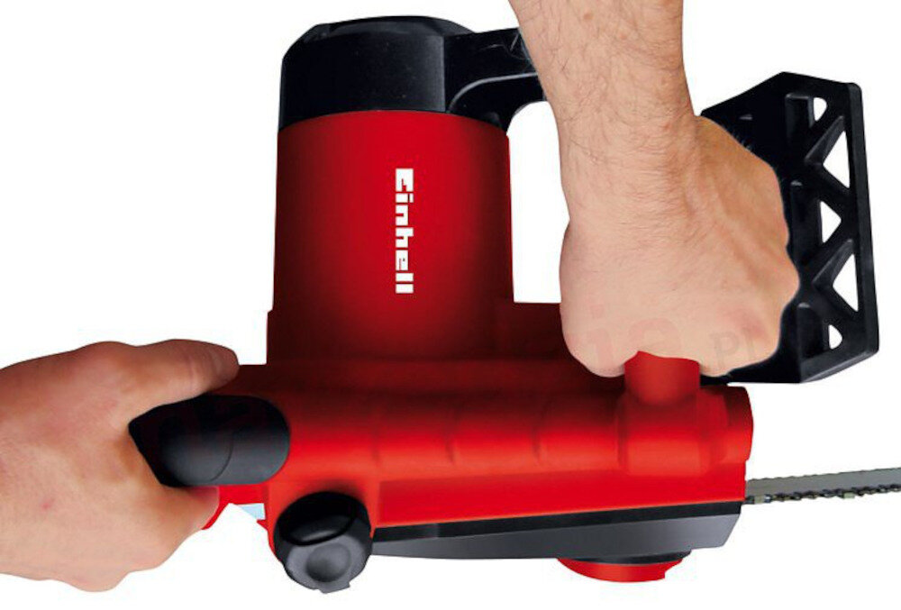 Osoba trzyma czerwoną piłę łańcuchową z widocznym logo \'Einhell\'.