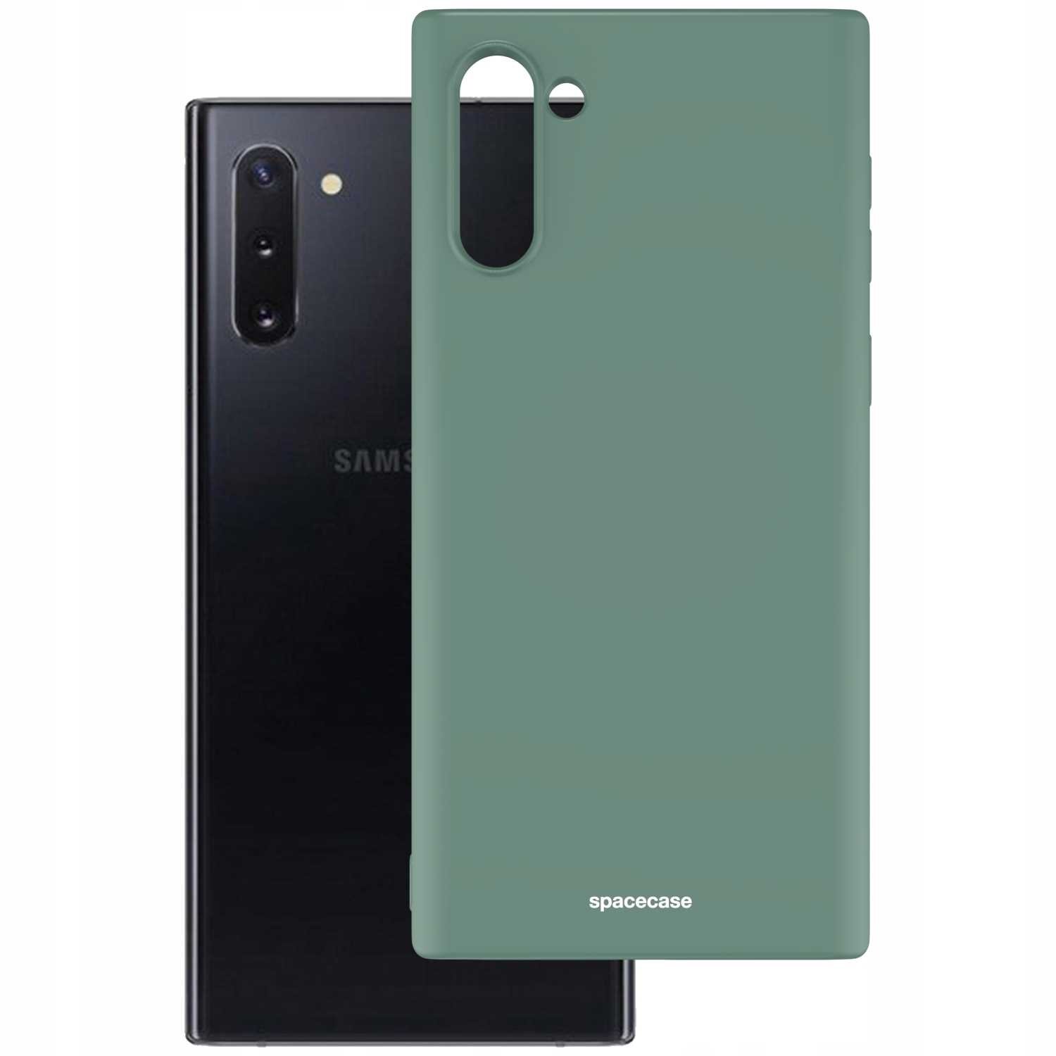 Na obrazie widoczne jest zielone silikonowe etui z napisem \'spacecase\', przeznaczone do telefonu. W tle znajduje się czarny telefon z widocznym logo \'SAMSUNG\'.