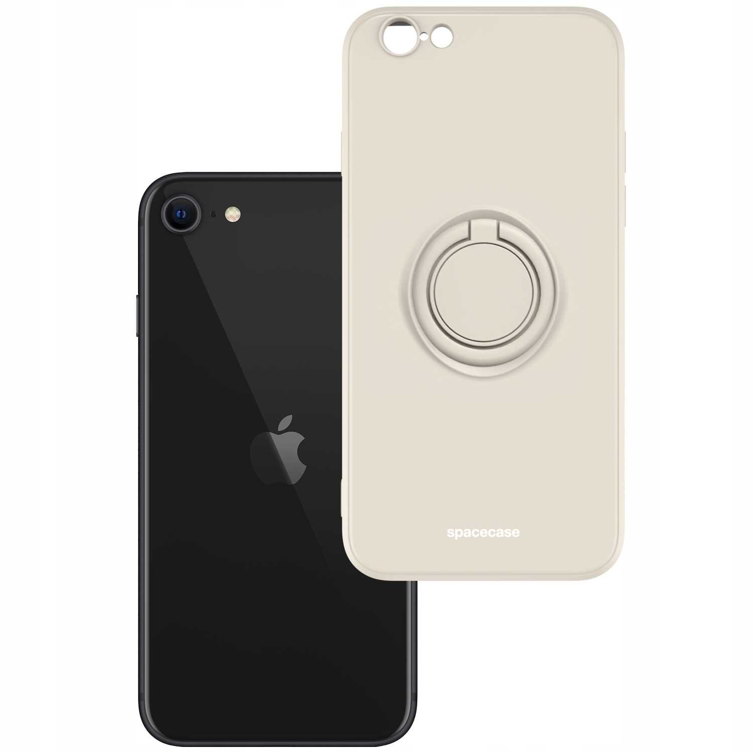 Na obrazie widoczne jest beżowe silikonowe etui z pierścieniem, obok czarnego telefonu z logo jabłka. Na etui znajduje się napis \'spacecase\'.