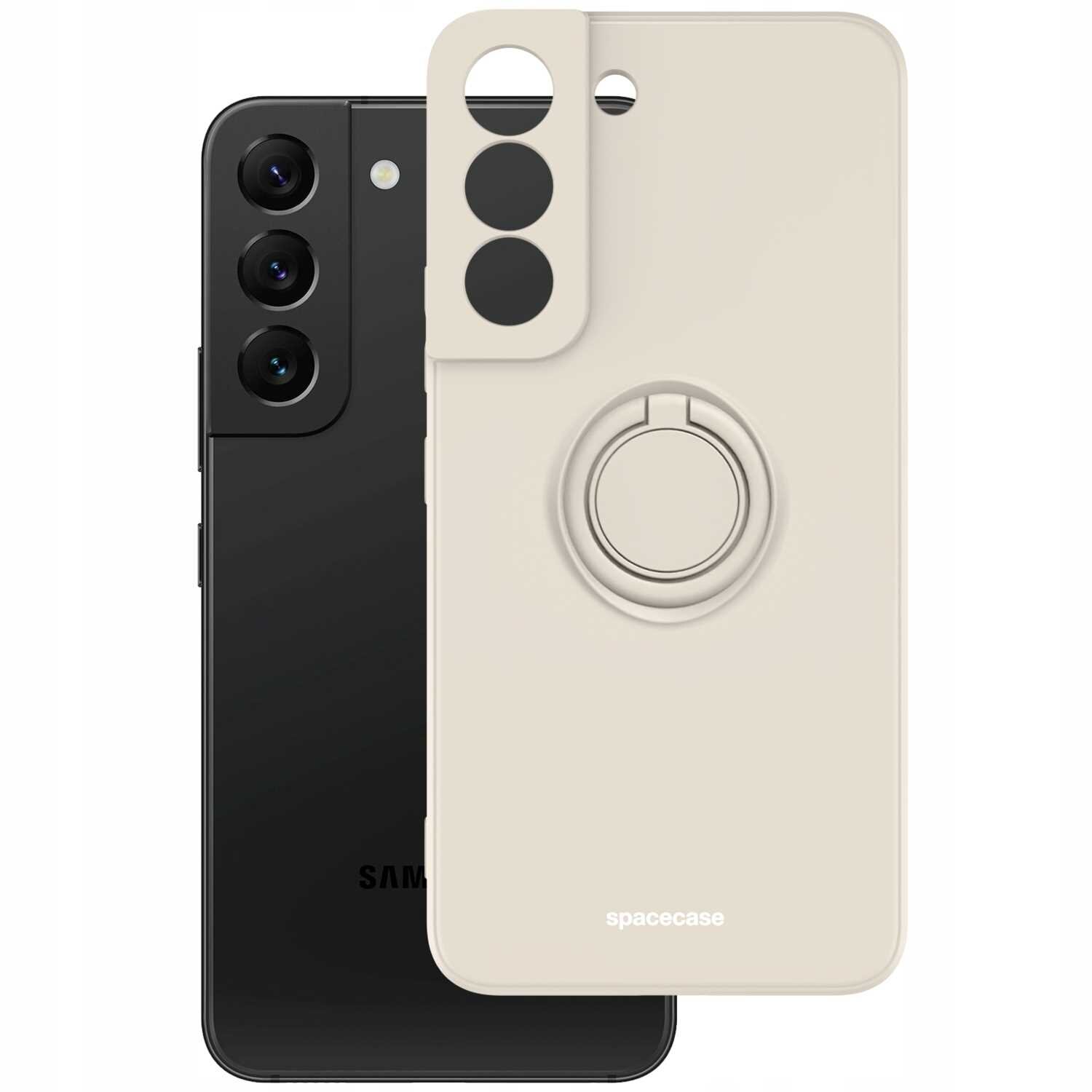 Na obrazie widoczne jest beżowe silikonowe etui z pierścieniem na telefon, z napisem \'spacecase\'. W tle znajduje się czarny telefon z trzema obiektywami aparatu.