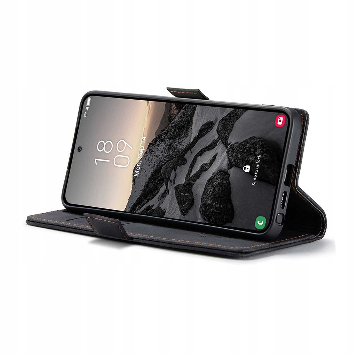 Smartfon w czarnym etui z klapką ustawiony w pozycji poziomej, wyświetlający ekran z godziną 18:09 i datą Pon, Sep 12. Etui ma widoczne przeszycia i funkcję stojaka.