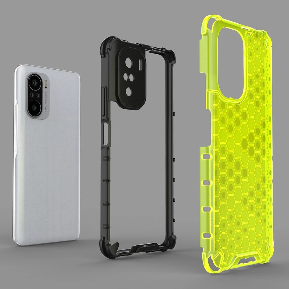 Obraz przedstawia trzy elementy: telefon, czarną ramkę ochronną oraz żółty pokrowiec z wzorem plastra miodu. Telefon ma srebrną obudowę i widoczne trzy obiektywy aparatu.