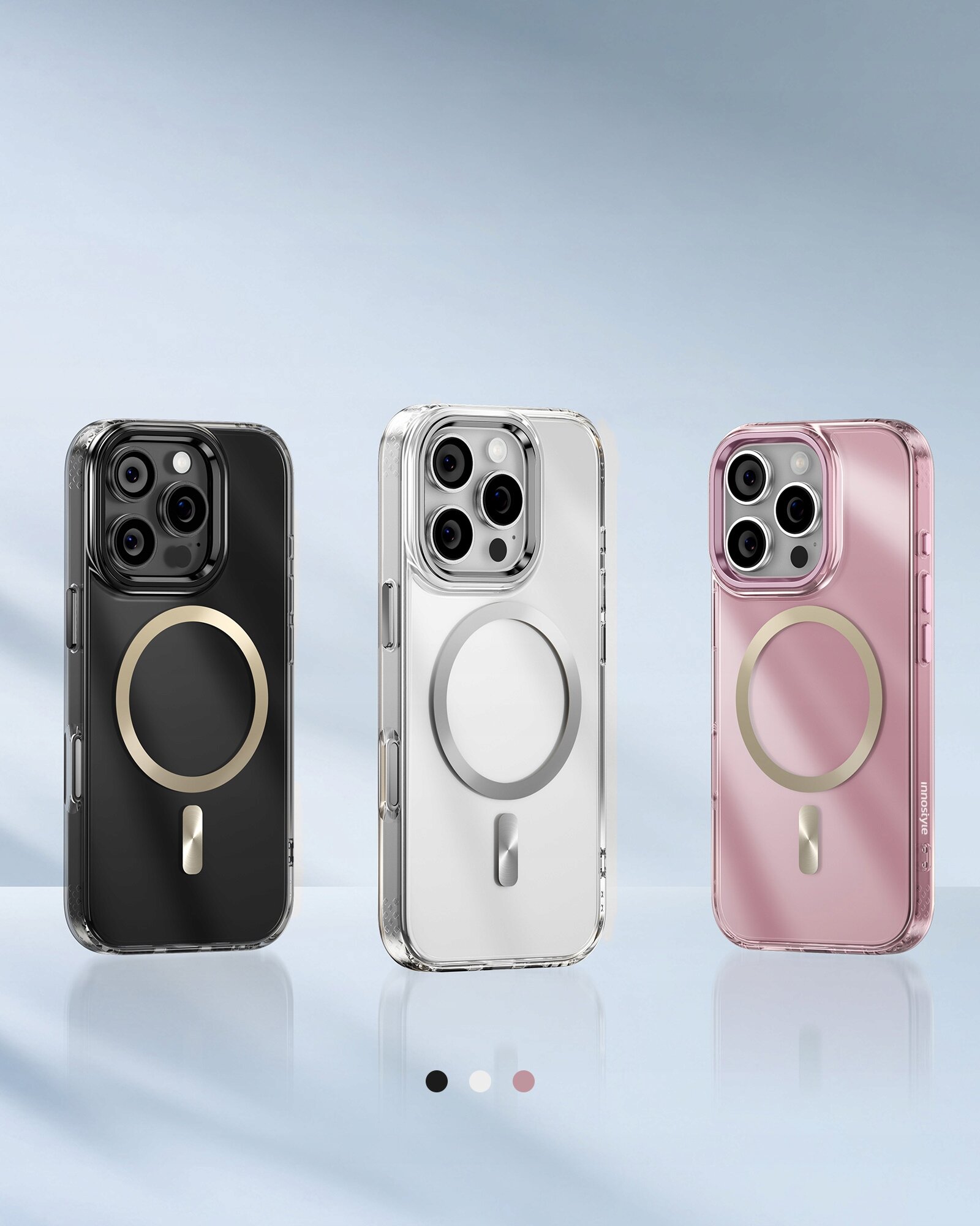 Na obrazie widoczne są trzy etui na telefon w kolorach czarnym, białym i różowym, każde z okrągłym wzorem na tylnej części. Pod etui znajdują się trzy kropki w kolorach odpowiadających etui.