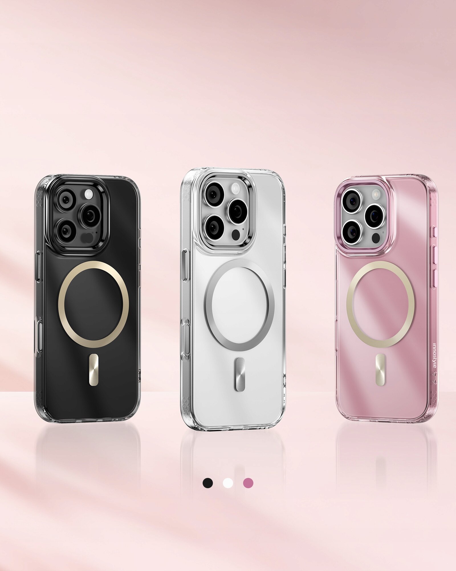 Trzy etui magnetyczne do iPhone 16 Pro w kolorach czarnym, białym i różowym, każde z okrągłym wzorem na tylnej części. Tło jest w odcieniach różu, a na dole widoczne są trzy kropki w kolorach odpowiadających etui.
