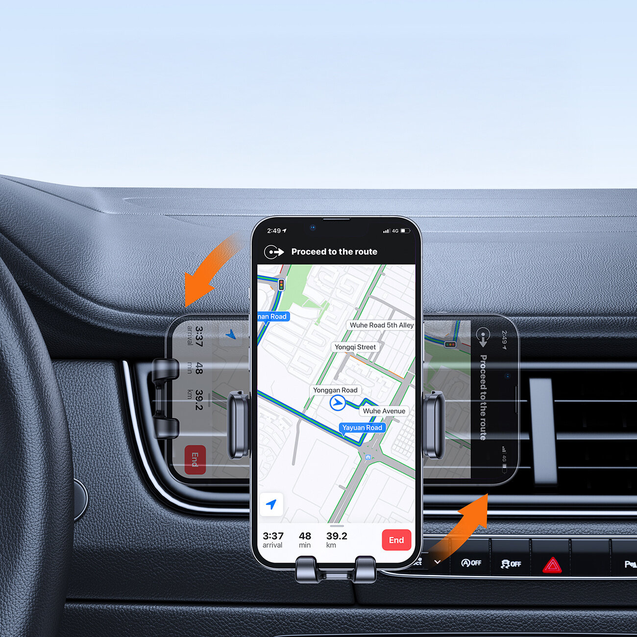 Wnętrze samochodu z zamontowanym uchwytem na telefon w kratce nawiewu, w którym znajduje się smartfon z włączoną nawigacją. Na ekranie telefonu widoczna jest mapa z trasą oraz tekst: \'Proceed to the route\'.