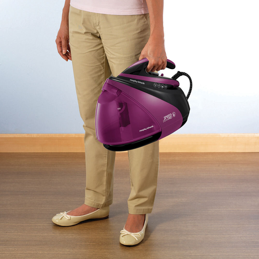 Osoba trzyma fioletowy generator pary z widocznym napisem \'morphy richards SPEED STEAM PRO\'.
