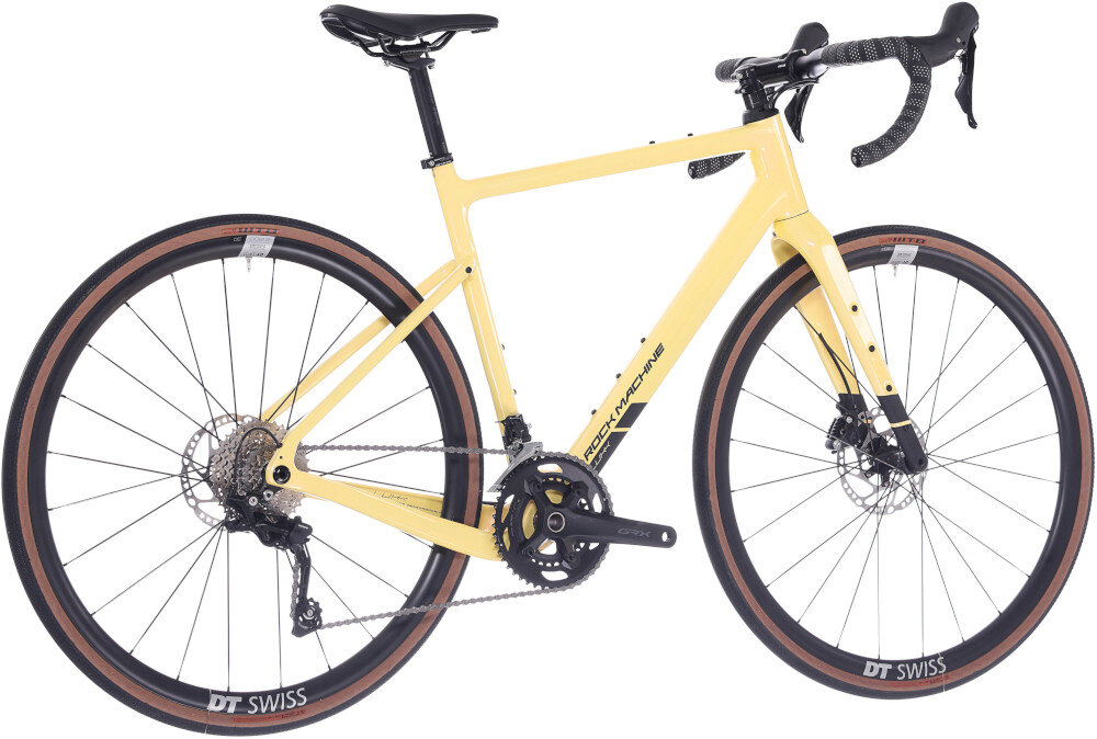 Rower gravel ROCK MACHINE Lukk Cr 65 U22 28 cali Żółty rower na białym tle widoczny od tyłu pod skosem łańcuch SHIMANO typu CN-LG500 do różnych napędów płynne przenoszenie mocy z pedałów na koła wysoka odporność na zużycie