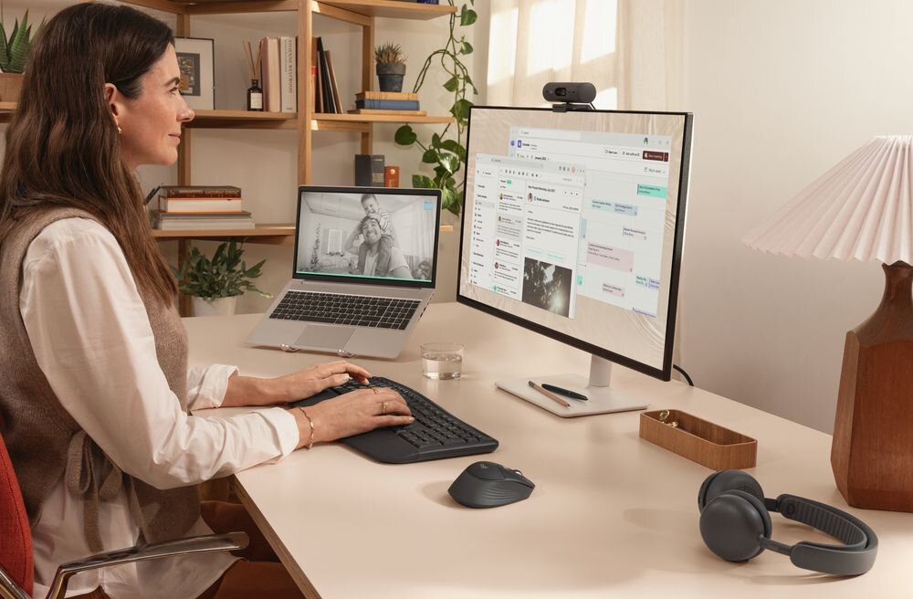 LOGITECH Signature Comfort Plus MK880 Funkcja Easy-Switch kilku urządzeń jednocześnie komputer, laptop i tablet szybkiego przełączania się między nimi jednym kliknięciem - klawiatura z myszką przed monitorem, obok słuchawki