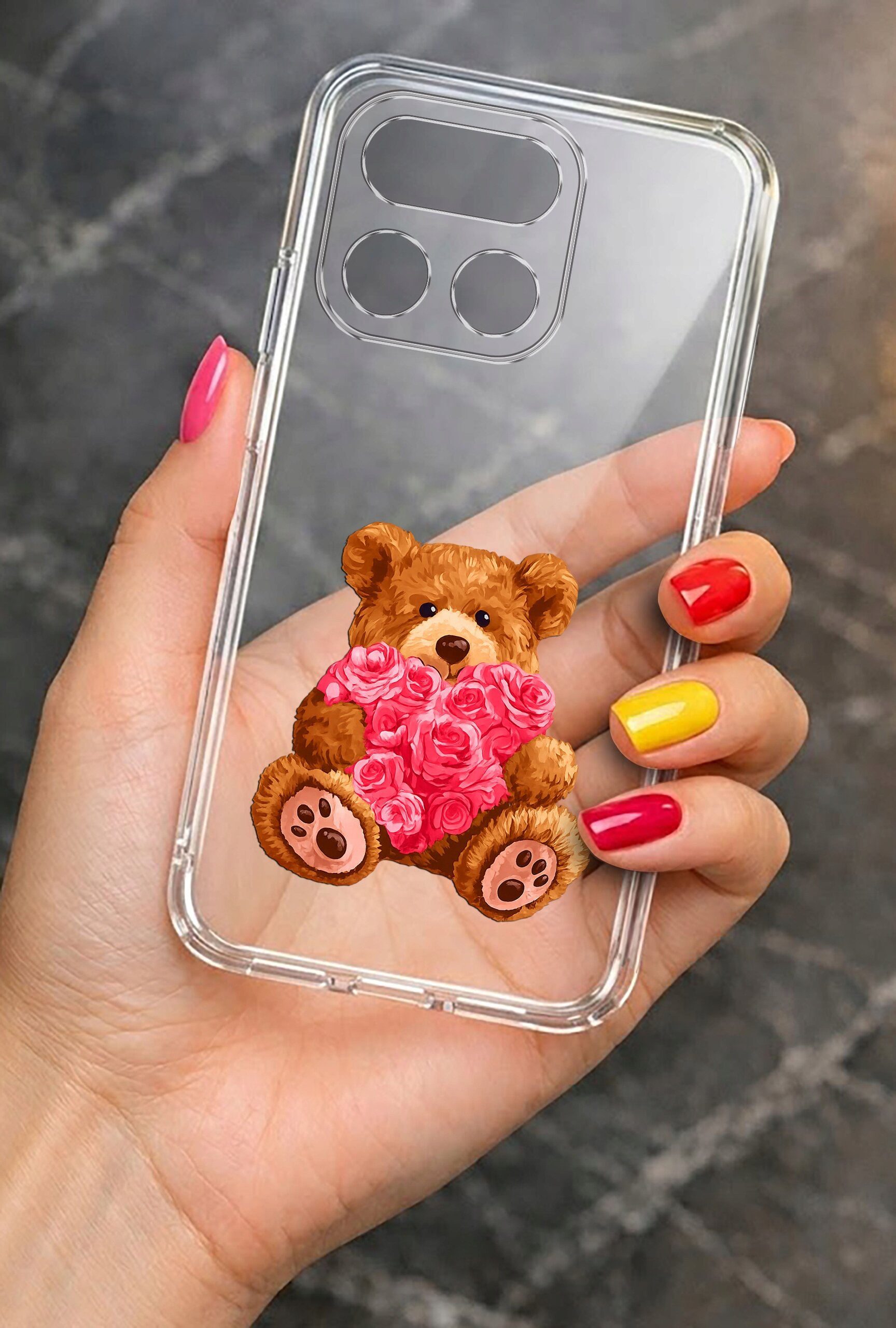 Przezroczyste etui na telefon z nadrukiem misia trzymającego serce z różowych róż. Etui jest trzymane w dłoni z kolorowymi paznokciami.