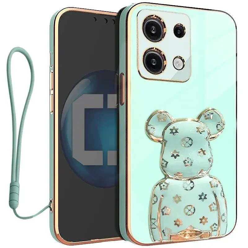 Etui na telefon w kolorze miętowym z przezroczystym uchwytem w kształcie misia ozdobionym gwiazdkami. Do etui dołączona jest smycz w dopasowanym kolorze.